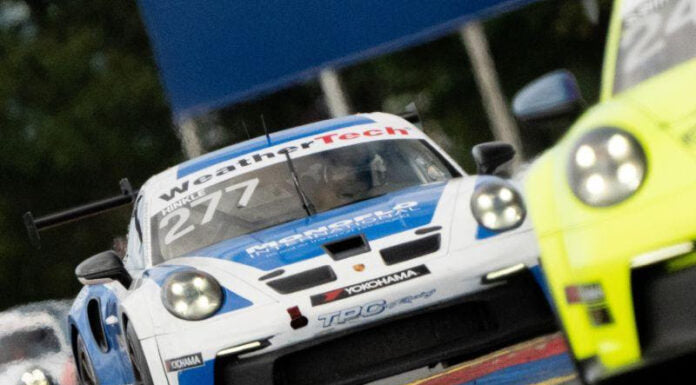 Angled image of a blue and white Porsche race car.